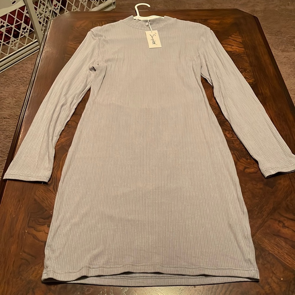 NWT GORGEOUS Long sleeve ribbed mock turtleneck with a triangular open back.